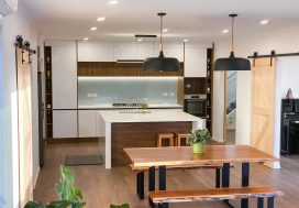 Modern kitchen with island and wooden accents, ideal for family and group gatherings.
