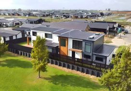 Modern eco-friendly residential homes with landscaped gardens in a new suburb, promoting community and sustainability.