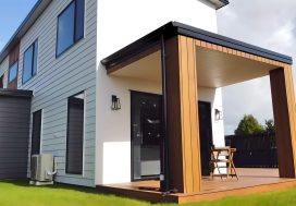 Modern New Zealand home with stylish wooden deck and outdoor seating, perfect for family gatherings.