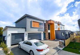 Contemporary residential home with modern design, grey and wood accents, and spacious driveway, featured on Friendship Builders NZ.
