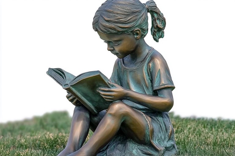 girl reading garden statue