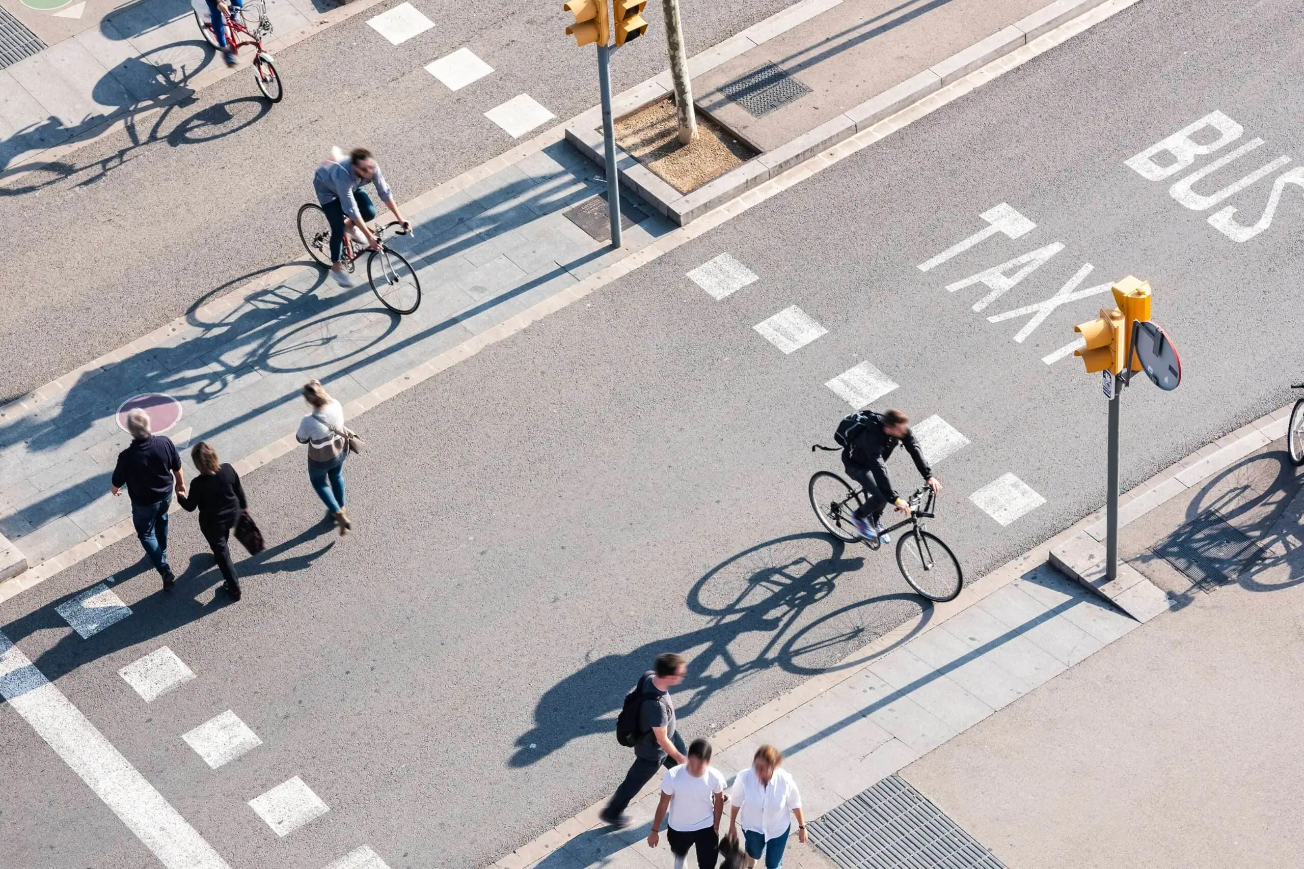 Pedestrian crosswalk at a busy Boston intersection with approaching vehicles