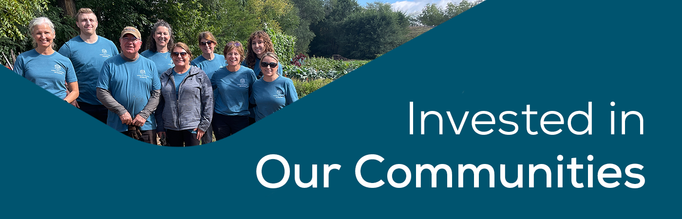 Invested in Our Communities tagline with group of Trust Point staff volunteering