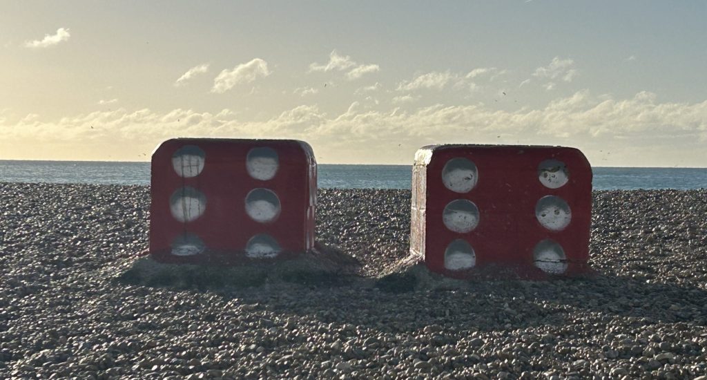 Crisis communications: staying in the driver's seat 3 Two large dice on a beach showing lucky sixes.