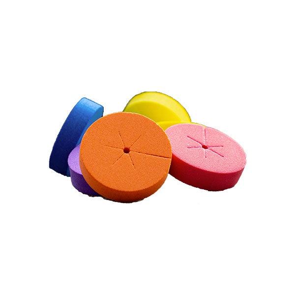 Brightly colored foam sponges in various shades including blue, purple, orange, yellow, and pink.