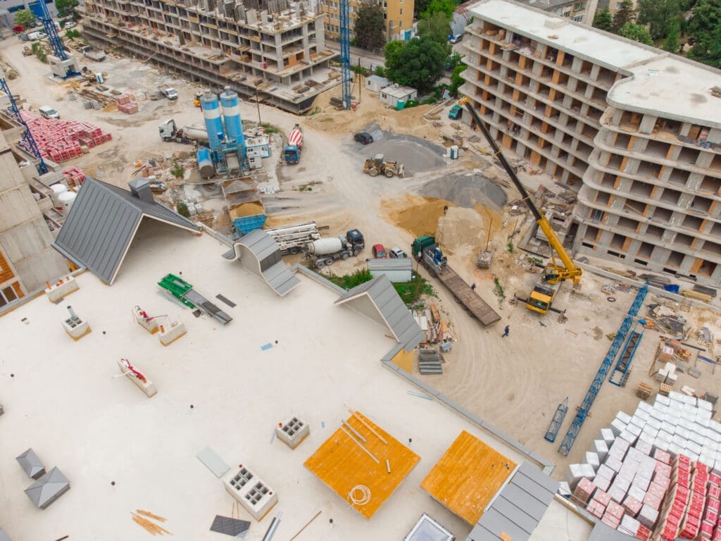 Aerial view of a large construction site with multiple buildings under construction.