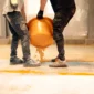 construction workers pouring orange epoxy resin on 2025 02 11 05 11 21 utc 85x85
