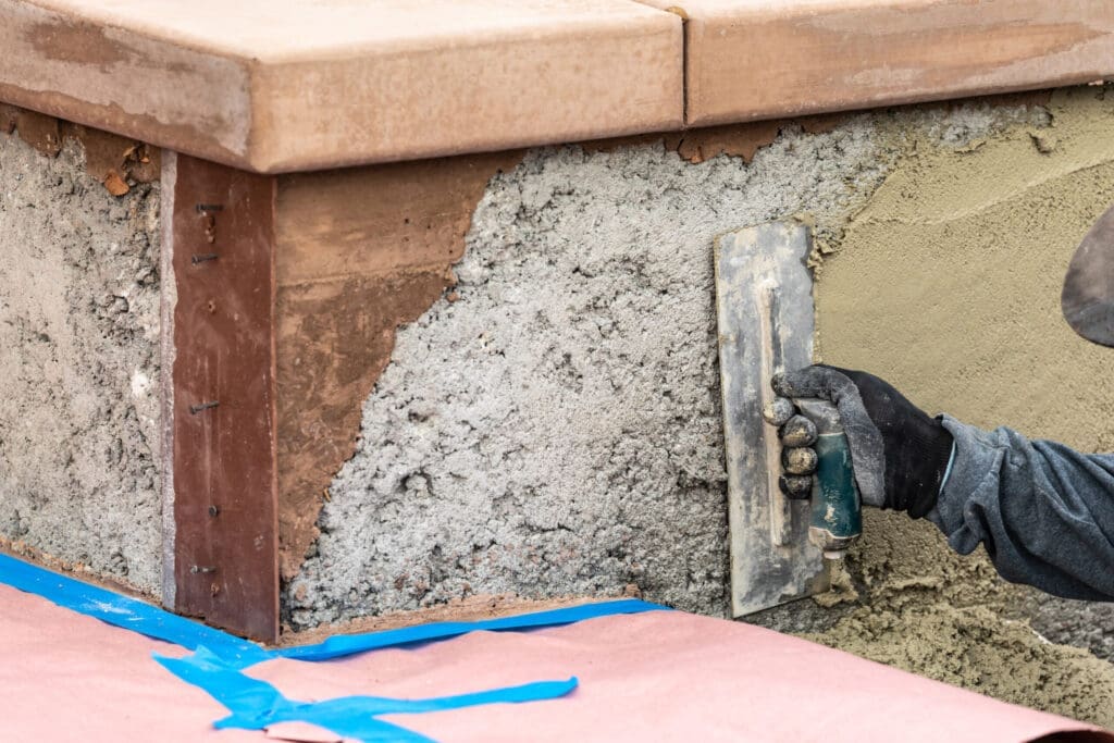 Worker applying plaster to a wall with a trowel