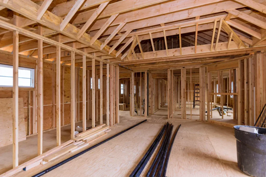 Interior view of a house under construction with exposed wooden framing
