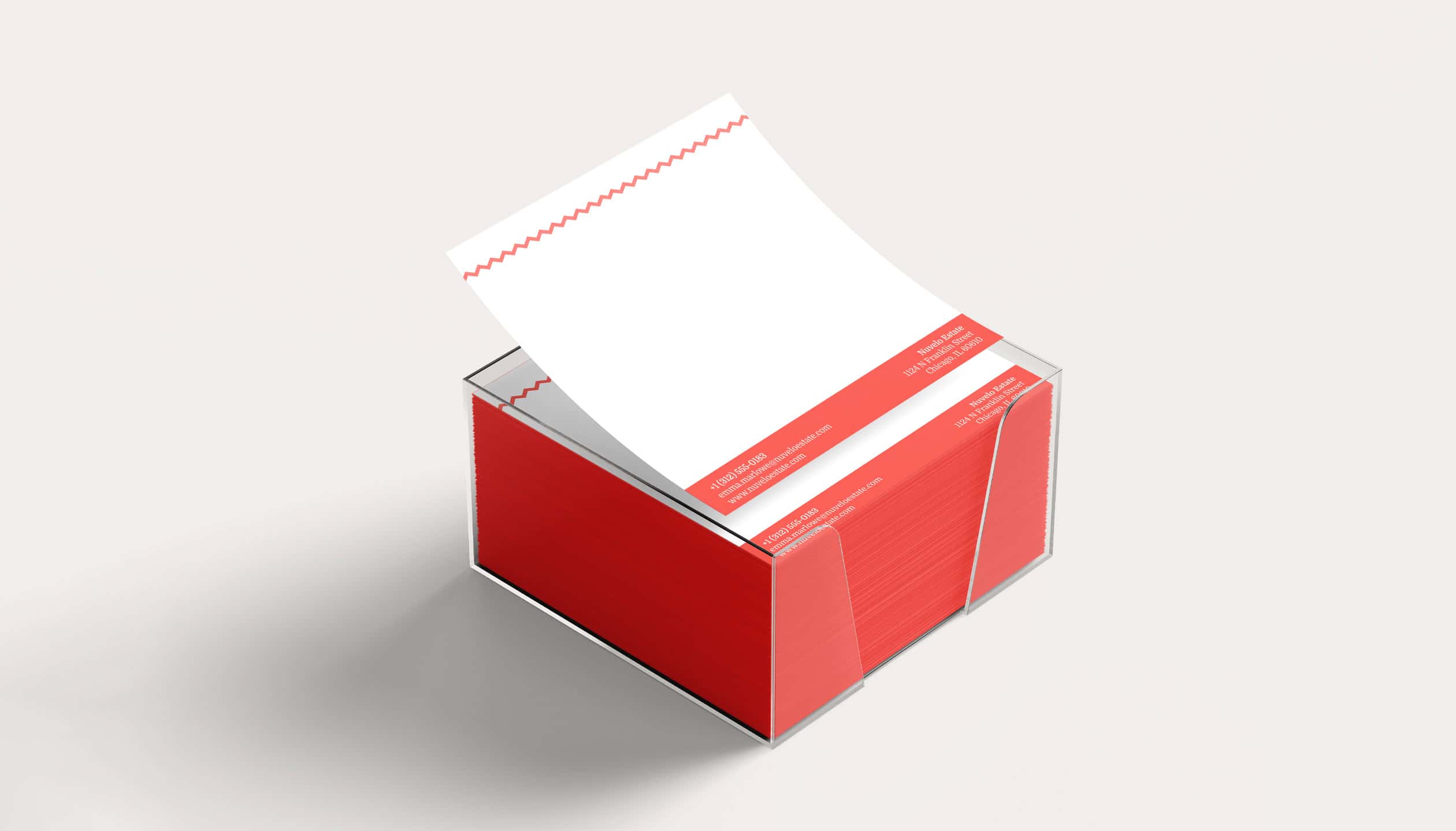 Nuvelo Estate branded note paper holder with red base and contact details on each sheet