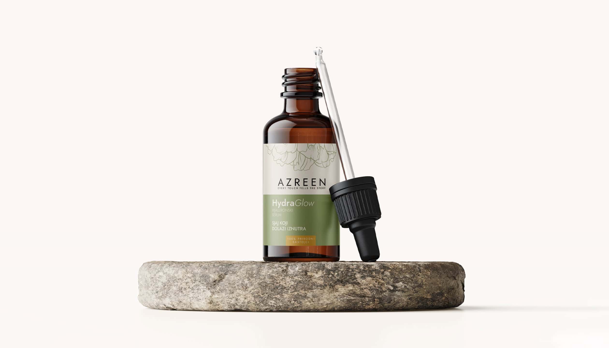azreen-skincare-serum-premium-packaging-design Amber glass dropper bottle of Azreen HydraGlow serum with elegant label design, placed on a natural stone stand, minimalist product photography