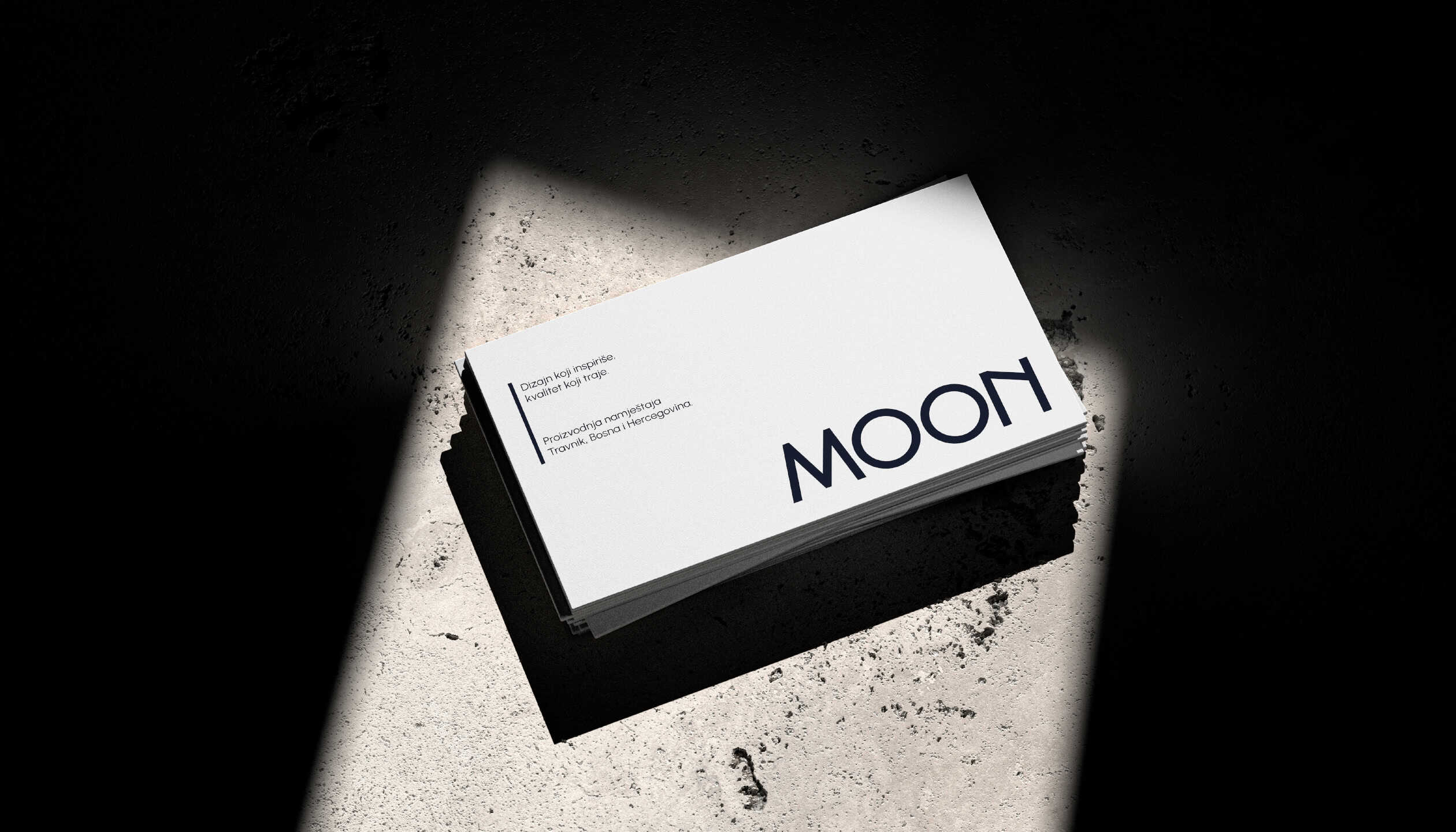 Minimalist business card design for MOON furniture brand, featuring clean layout, logo and brand message on textured background