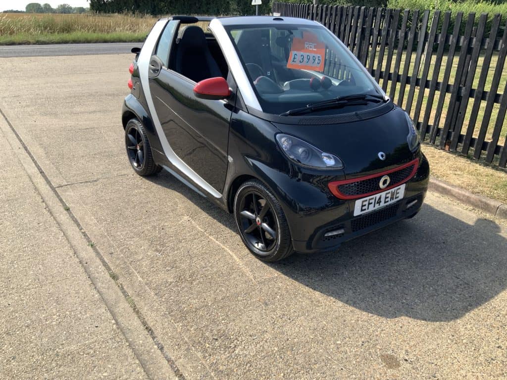 Black Smart ForTwo convertible with red side mirrors for sale at Greens Garage Suffolk.