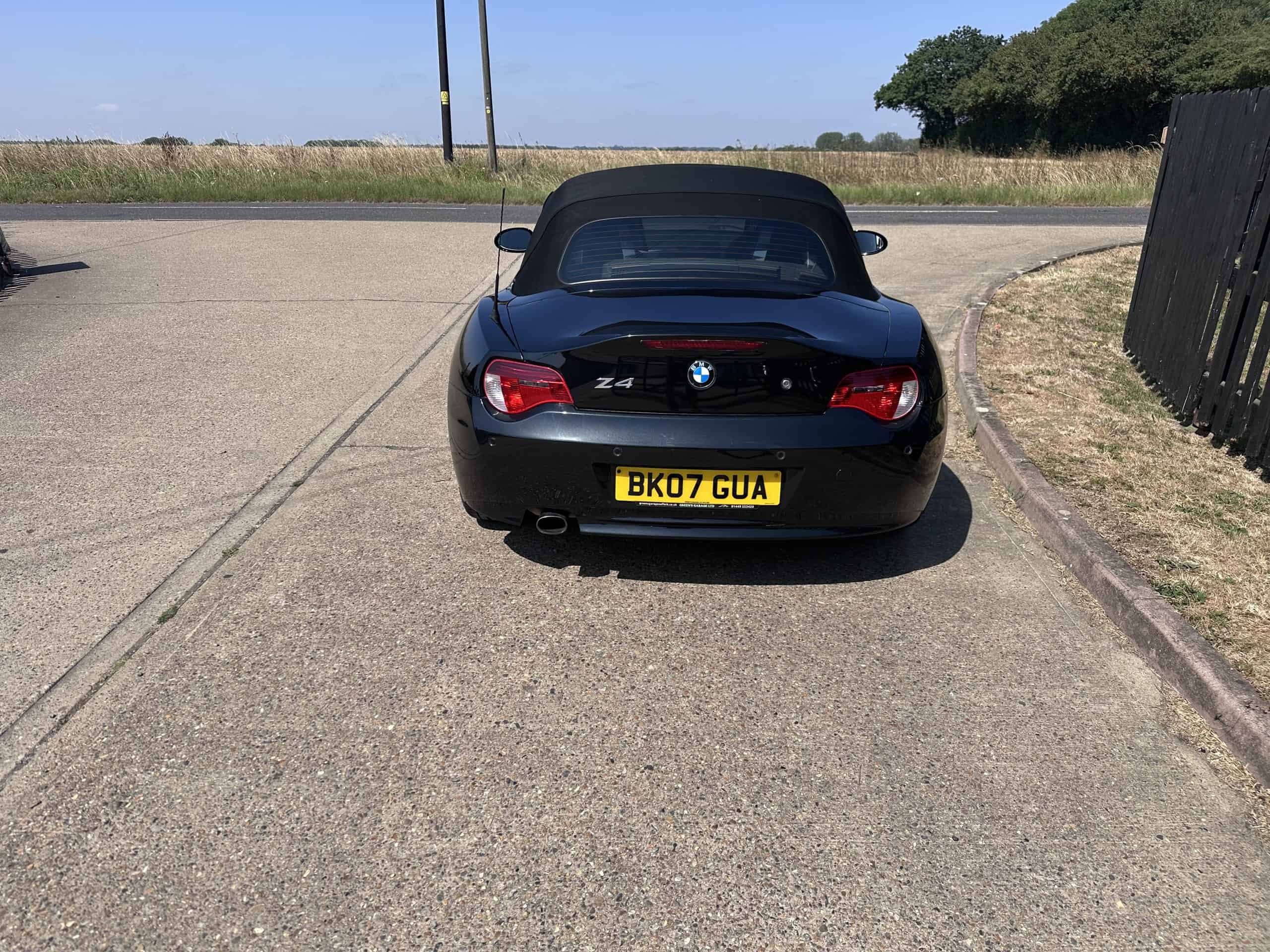 Black BMW Z4 convertible with red interior features in Suffolk.
