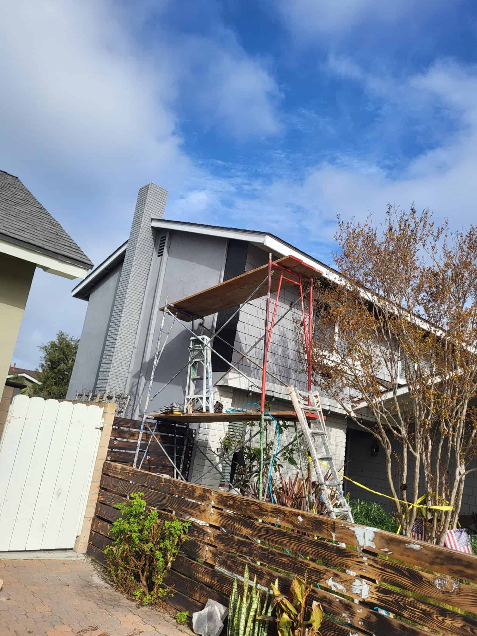Scaffolding at a residential home under construction, showcasing exterior renovation work with a focus on professional roofing, siding, and building services by Gregorio Soria Construction.