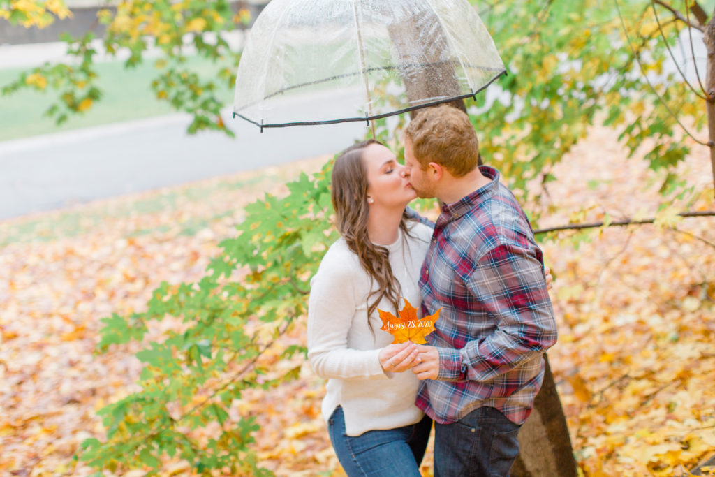 couple kissing holding a leaf with wedding date under umbrella
- Rainy Day Engagement Session Downtown Ottawa - Photo Locations  Grey Loft Studio - Ottawa Wedding Photographer & Videographer
