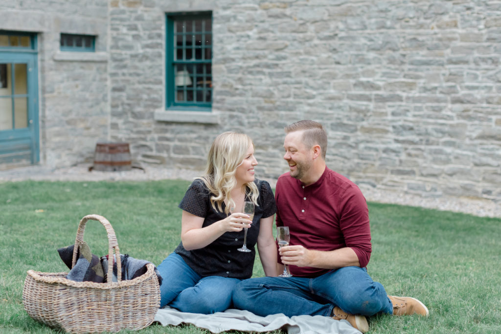 pinhey point engagement session black and burgandy fall colours with puppy uring an engagement session engaged couple walking Ottawa during Sunset  grey loft studio ottawa wedding photographer videographer engagement kanata orleans nepean beautiful locations for engagement photos in ottawa dominion arboretum magnolia blooms spring photos ottawa photo studio puppy ottawa dogs in engagement photos ottawa dunrobin ontario wedding photographer