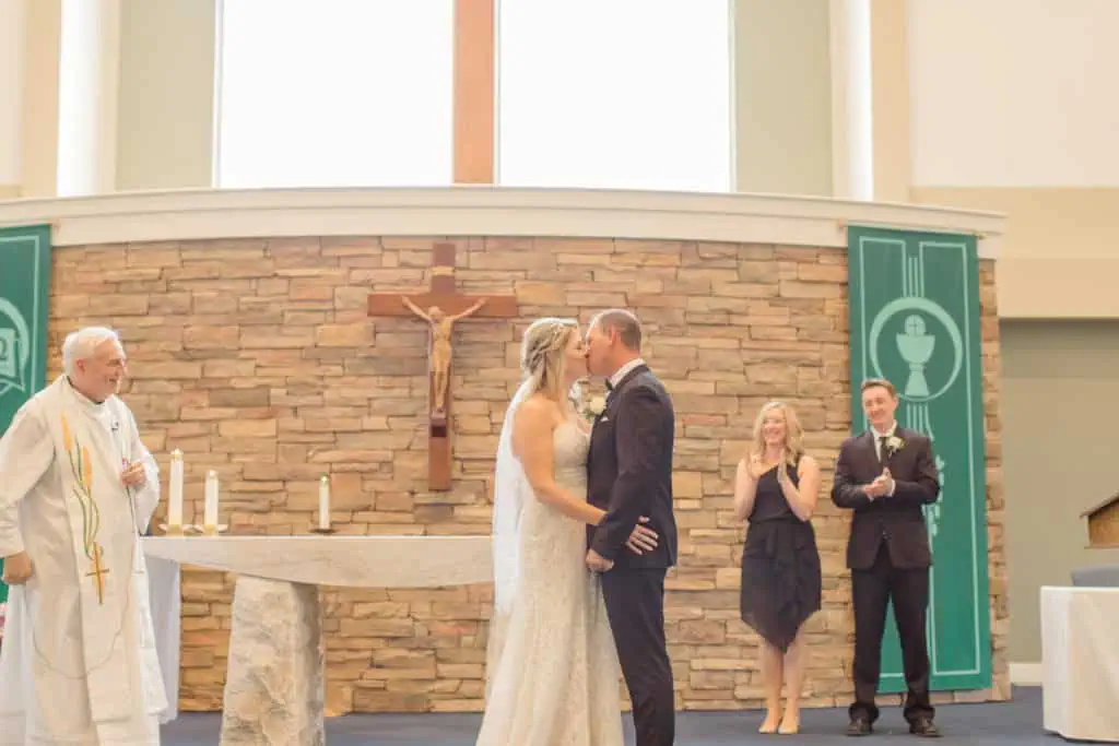 First Kiss Photo in Holy Spirit Catholic Church - Holy Spirit Catholic Church Stittsville - Bride with Bridesmaids - Black and White Theme Wedding - Romantic Wedding at NeXt in Stittsville - Grey Loft Studio - Ottawa Wedding Photographer - Ottawa Wedding Photo & Video Team