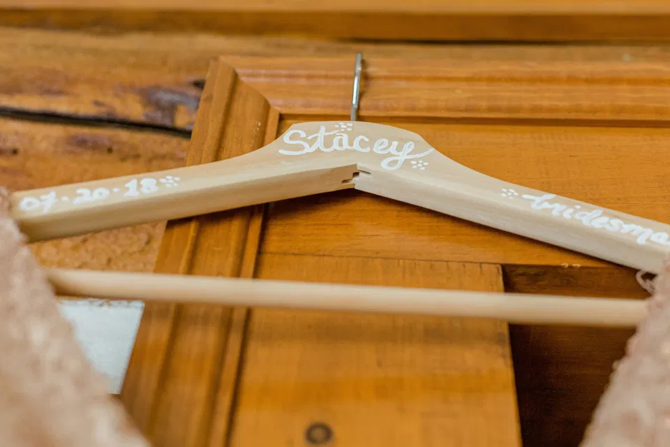 Custom Bridesmaid Hangers - Getting Ready Space - Stonefields Estate-  Bright and Airy -  Natural Wedding Posing - Ideas for what to wear for Blush Wedding Photography, Modern Wedding Blush &. Navy Wardrobe inspiration- Unsure of what to wear for your wedding, we've got you! Romantic white with greenery, blush and navy theme. Grey Loft Studio is Stonefields Wedding and Engagement Photographer for Real couples, showcasing photos that are modern, bright, and fun.