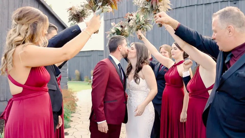 Kiss under Bridge by Wedding Party with Bouquets. Off-White, Silver, Greenery. Eucalyptus Leaves. An inspiration filled with soft neutrals, lush florals, and layers of romantic textures all set at Evermore Weddings and Events, Almonte Ontario. 
Grey Loft Studio shot with Canon 5D Mark 4. Ottawa Wedding Photographer & Videographer Team.