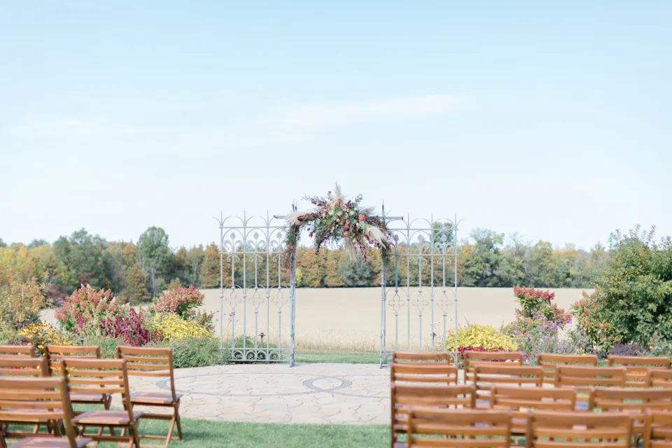 Beautiful Landscapes with beautiful Ceremony Decor -Floral inspiration - Outdoor Ceremony With Wooden Modern Brown Wood Chairs. Interlock, beautiful Landscapes at Evermore Weddings and Events, Almonte Ontario - Grey Loft Studio