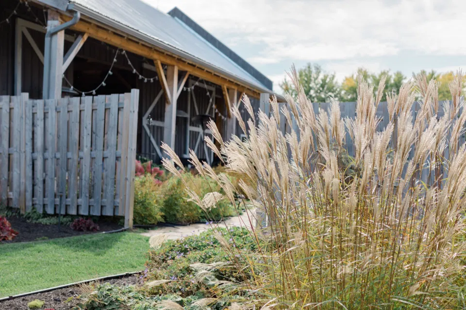 Beautiful Landscapes with beautiful Ceremony Decor -Floral inspiration - Outdoor Ceremony With Wooden Modern Brown Wood Chairs. Interlock, beautiful Landscapes at Evermore Weddings and Events, Almonte Ontario - Grey Loft Studio
