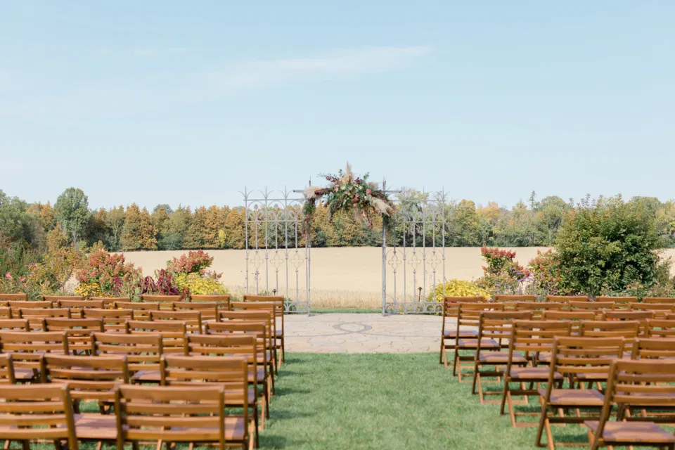 Beautiful Landscapes with beautiful Ceremony Decor -Floral inspiration - Outdoor Ceremony With Wooden Modern Brown Wood Chairs. Interlock, beautiful Landscapes at Evermore Weddings and Events, Almonte Ontario - Grey Loft Studio