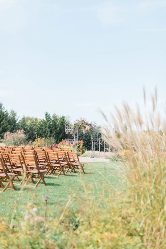 Beautiful Landscapes with beautiful Ceremony Decor -Floral inspiration - Outdoor Ceremony With Wooden Modern Brown Wood Chairs. Interlock, beautiful Landscapes at Evermore Weddings and Events, Almonte Ontario - Grey Loft Studio