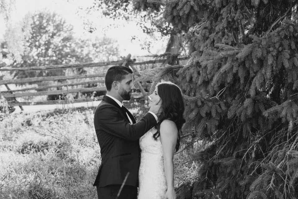 Black & White - Bride and Groom - Standing in a Field - Off-White, Silver, Greenery. Eucalyptus Leaves. An inspiration filled with soft neutrals, lush florals, and layers of romantic textures all set at Evermore Weddings and Events, Almonte Ontario. 
Grey Loft Studio shot with Canon 5D Mark 4. Ottawa Wedding Photographer & Videographer Team.