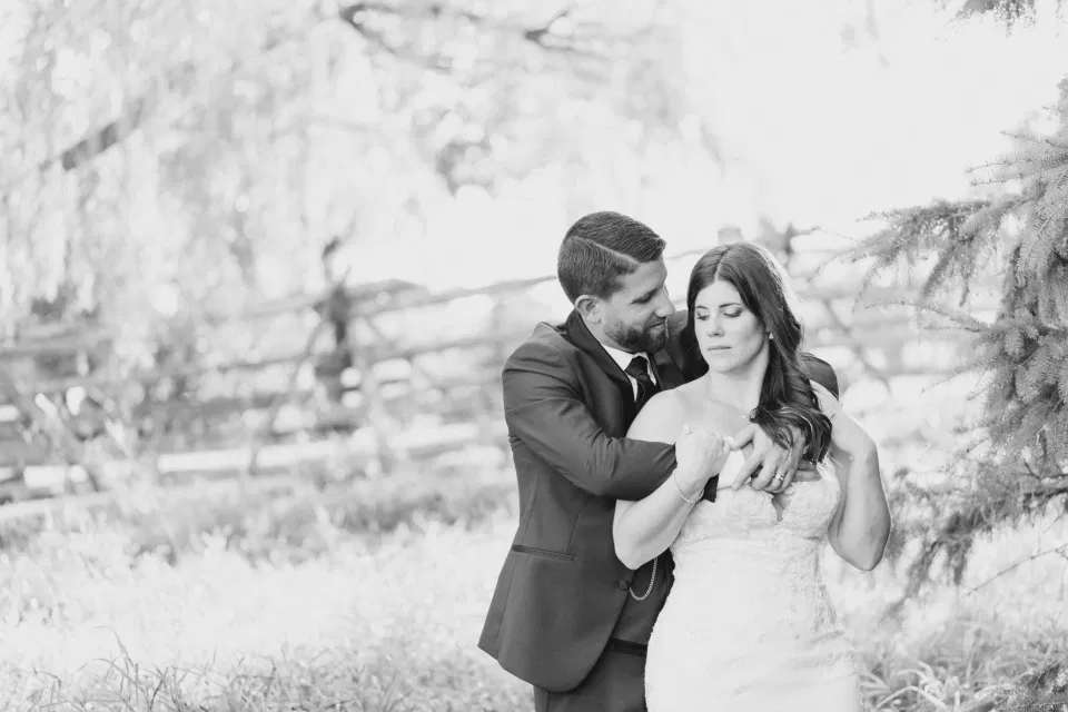 Black and White -  Bride and Groom - Standing in a Field - Off-White, Silver, Greenery. Eucalyptus Leaves. An inspiration filled with soft neutrals, lush florals, and layers of romantic textures all set at Evermore Weddings and Events, Almonte Ontario. 
Grey Loft Studio shot with Canon 5D Mark 4. Ottawa Wedding Photographer & Videographer Team.