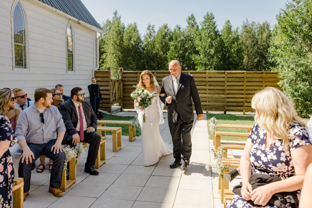 walking down the aisle at the cumberland belle june wedding