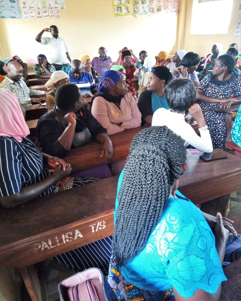 Fathers participating in a GRiD community dialogue on supporting adolescent girls through menstrual health and wellbeing conversations