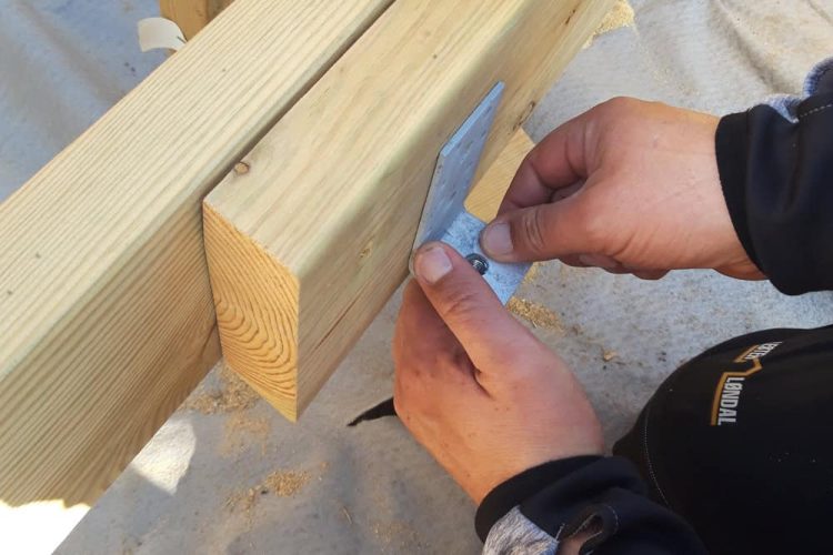 Mounting a L-bracket to a screw pile.