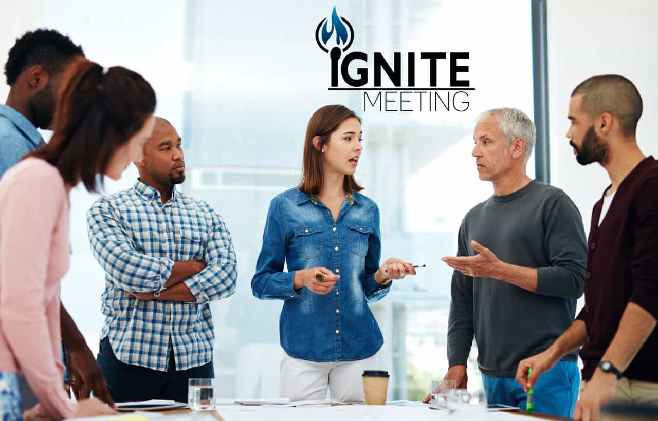 Diverse group of professionals engaged in a collaborative Ignite Meeting, discussing ideas around a conference table