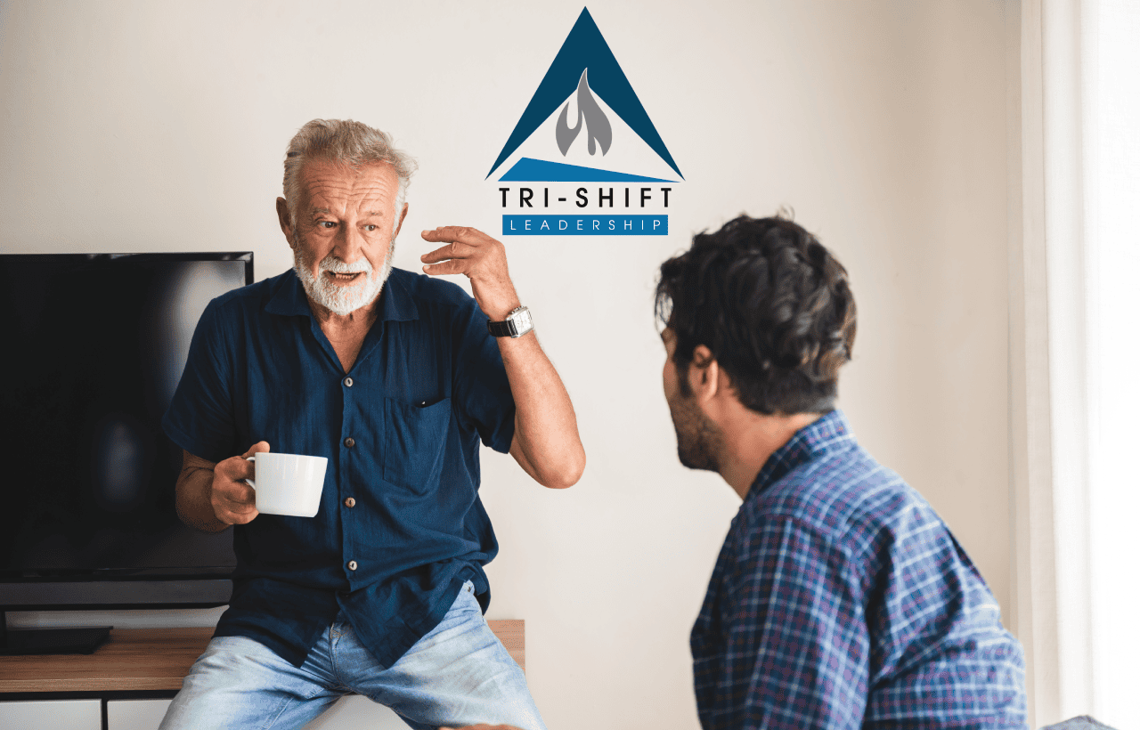 Older man and younger man engaged in a thoughtful conversation utilizing Tri-Shift Leadership tools