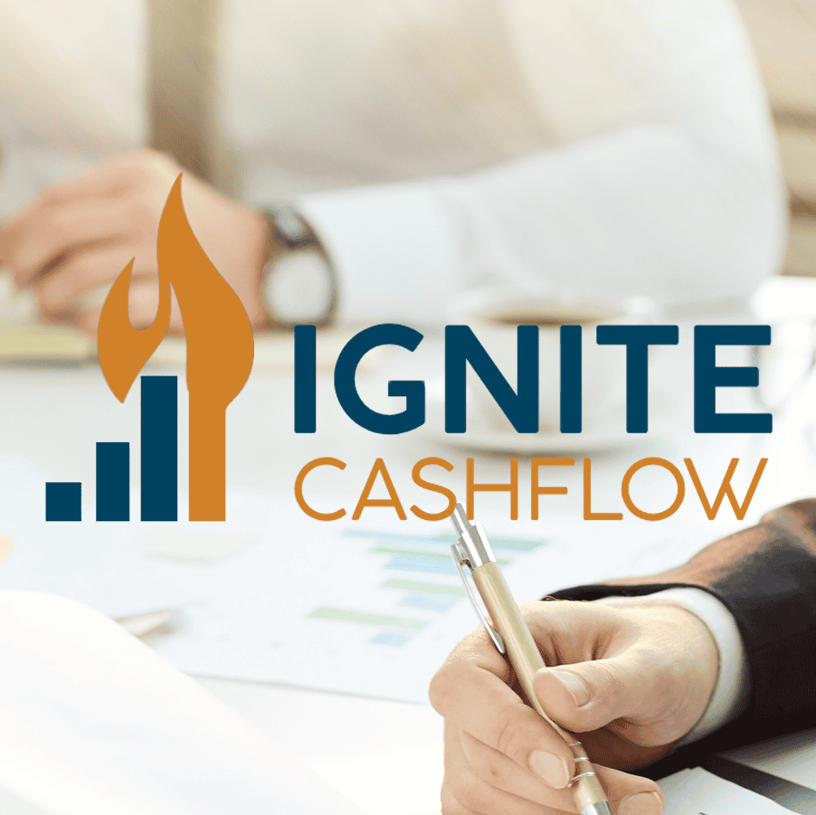 Grow Ignited team member reviewing financial reports beside Ignite Cashflow logo on business strategy materials