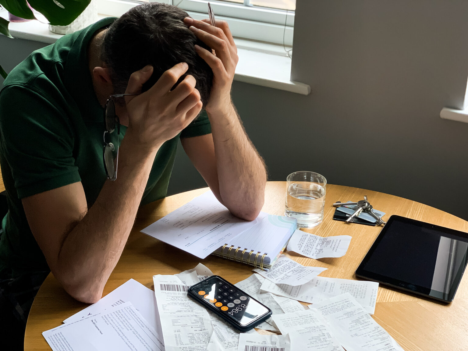 Business owner dealing with cash flow problems, unpaid invoices, bills, and expenses