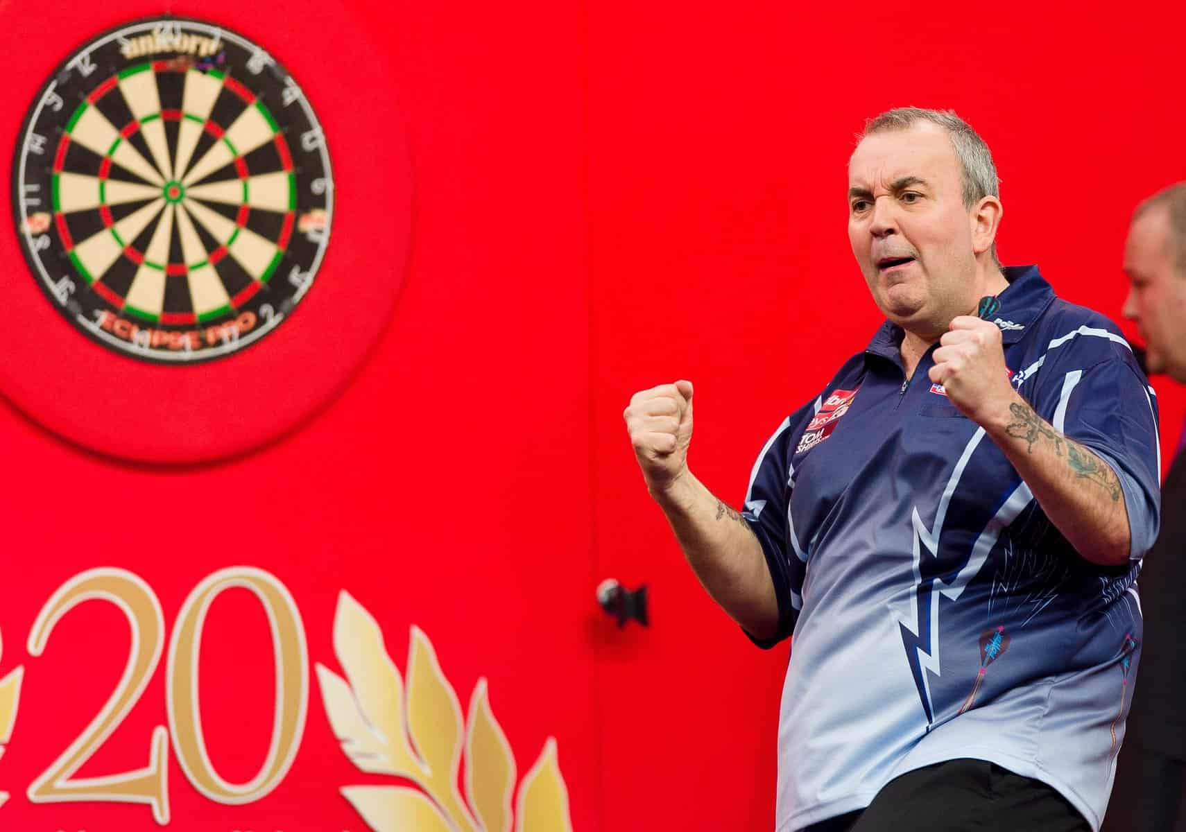 Phil Taylor of Britain reacts as he takes part in the PDC World Championship darts final against Michael van Gerwen of the Netherlands, at Alexandra Palace in north London on January 1, 2013. AFP PHOTO/Leon Neal (Photo credit should read LEON NEAL/AFP/Getty Images)