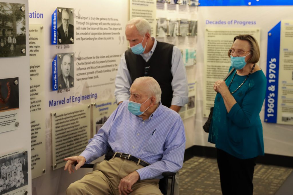 Three individuals inside the GSP Airport Museum