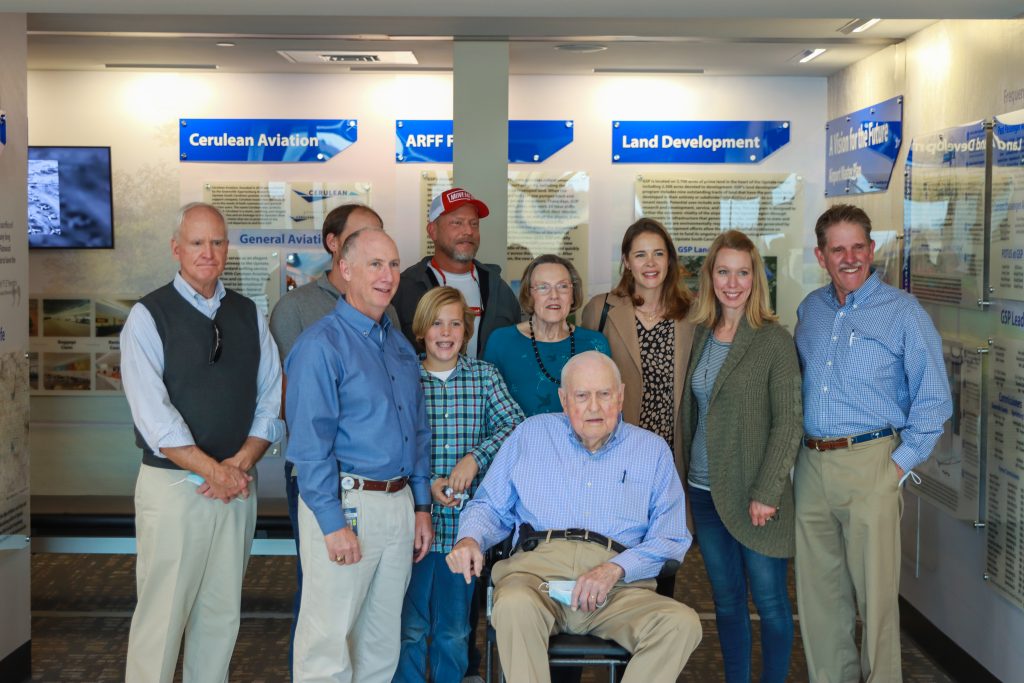 F.E. Hendrix and four generations of his family are joined by GSP President/CEO Dave Edwards in front of GSP Airport Museum