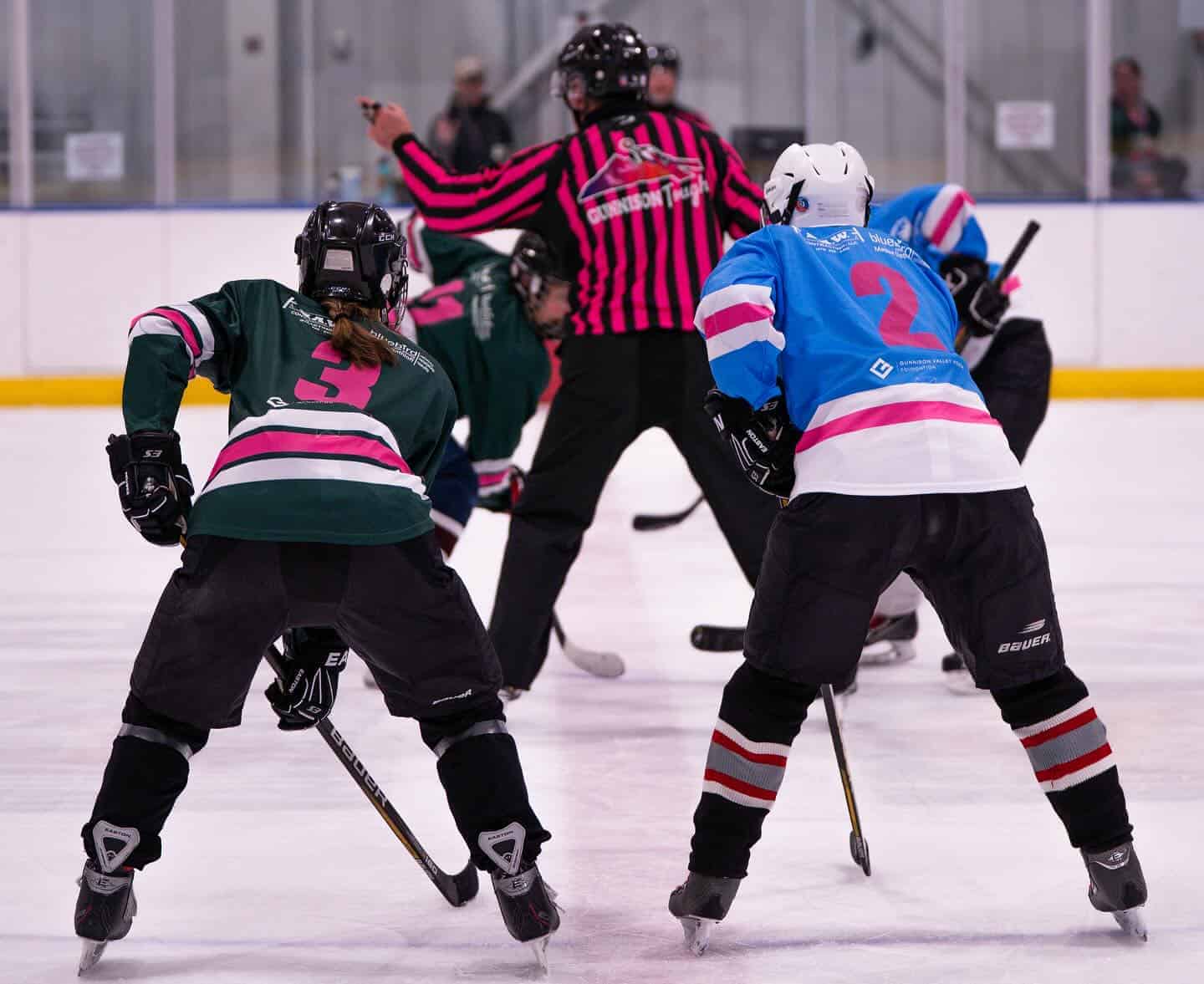 hockey players and ref at face off.