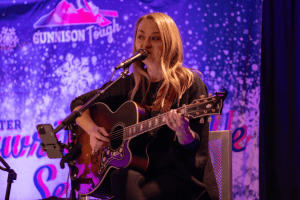 Autumn McEntiry singing and smiling.