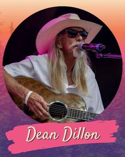 Dean Dillon playing a guitar and singing into a microphone.