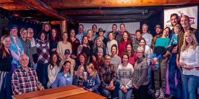 A large group of people attending the community dinner; leads to the February, 2026 Newsletter.