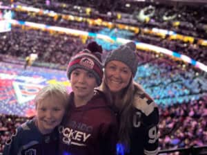 Theresa Henry and her 2 sons pose together at an Av's Hockey Game.