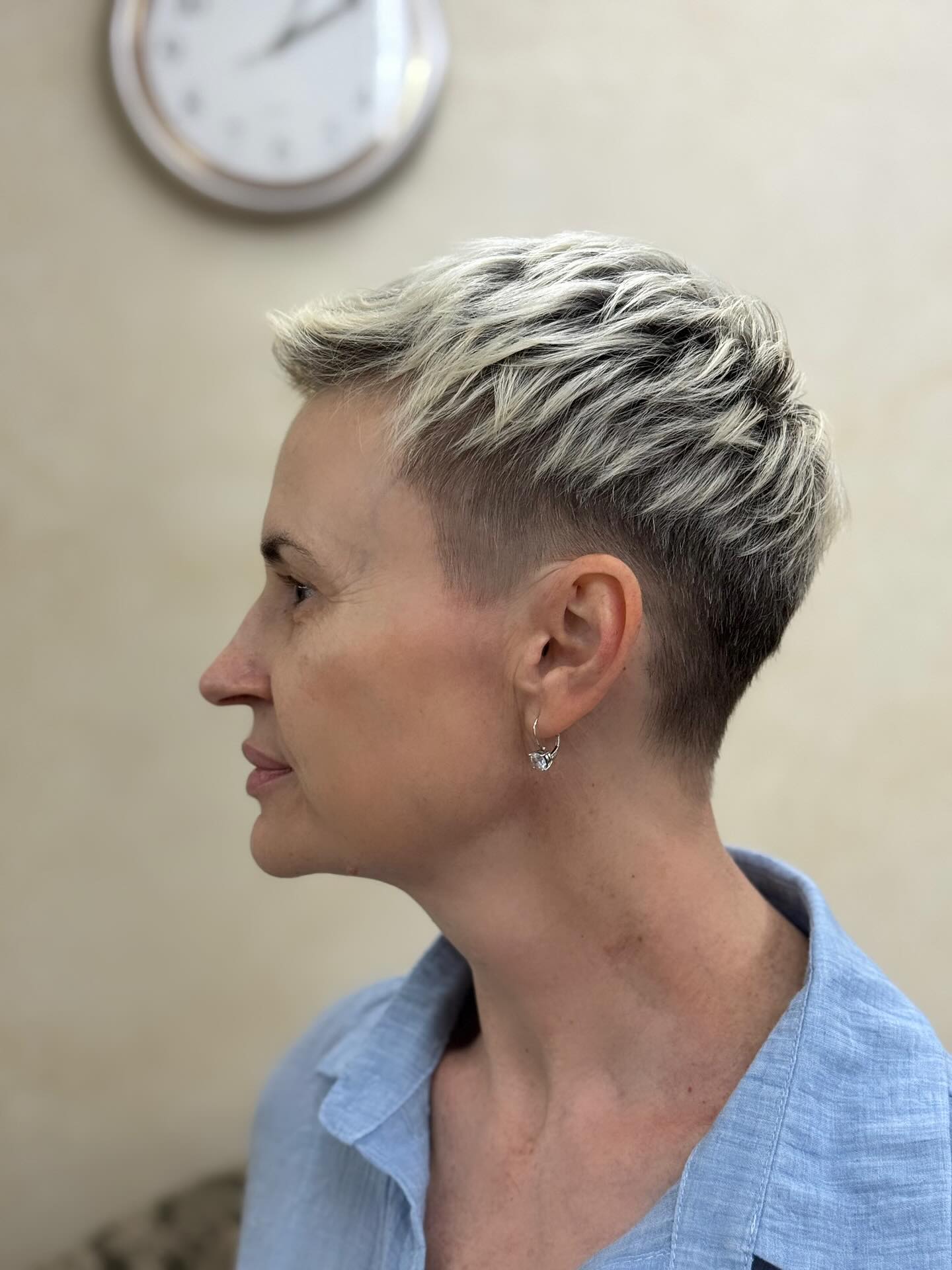 Blonde textured pixie with tapered sides side profile