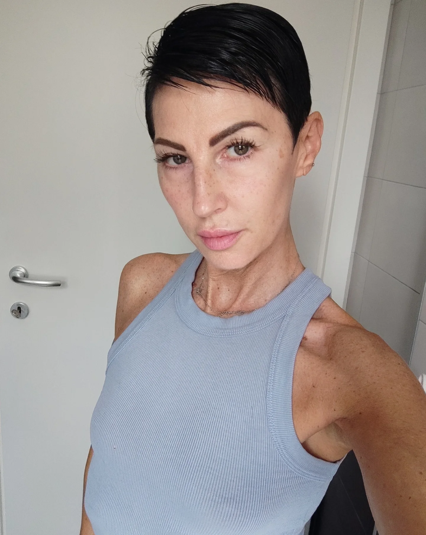 Sleek tapered pixie cut with smooth side swept top