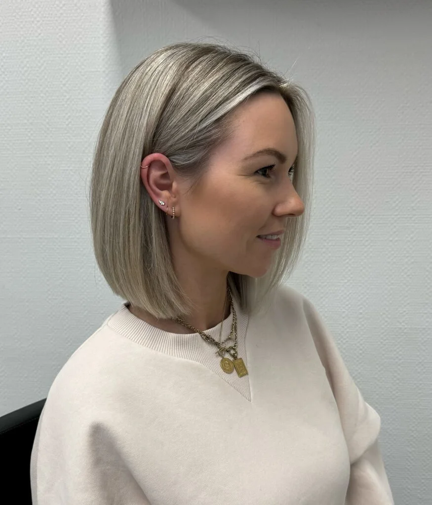 Soft blonde long bob with center part and natural volume