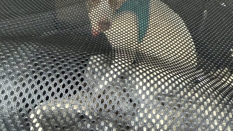 a dog traveling safely in a kennel