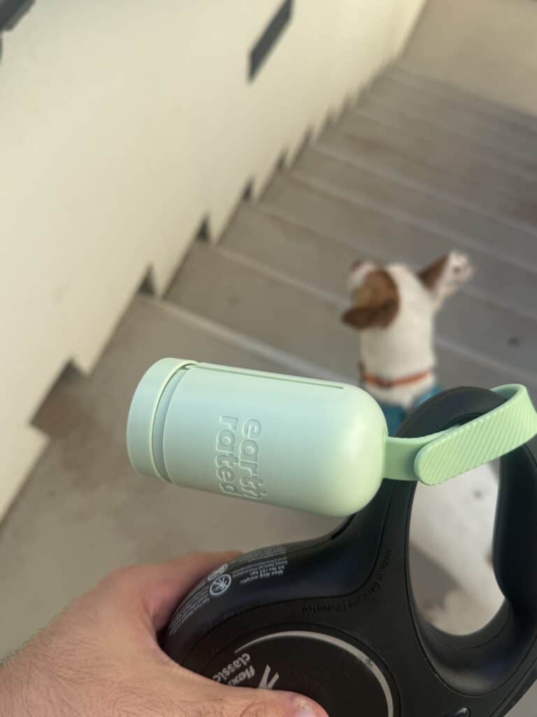 taking dog out with leash and bag dispenser